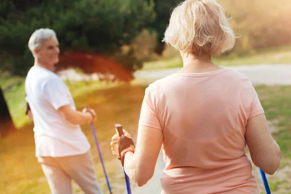 Sporty elderly woman looking at her husband — Stock Photo, Image