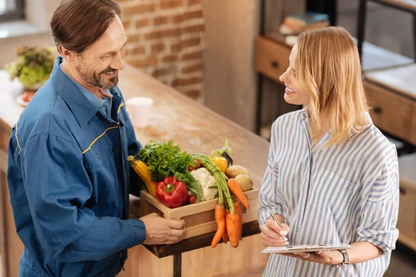 Polite sweet lady talking to a courier — Stock Photo, Image