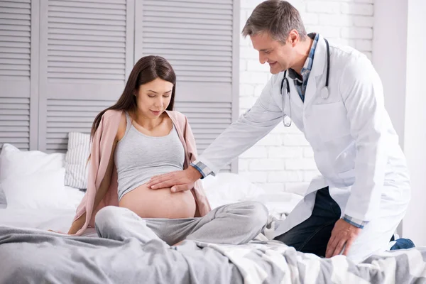 Attentive female looking at her belly — Stock Photo, Image