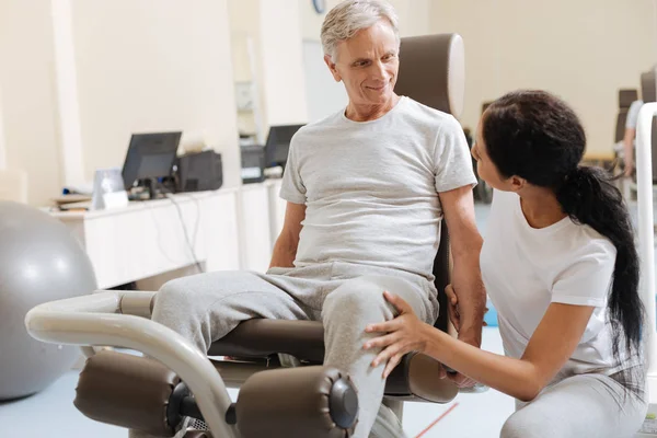 Attentive trainer listening to her patient