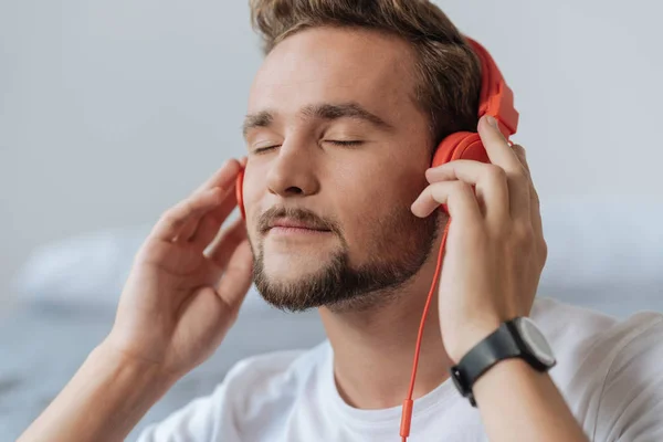 Portrait of delighted man that enjoying music — Stock Photo, Image