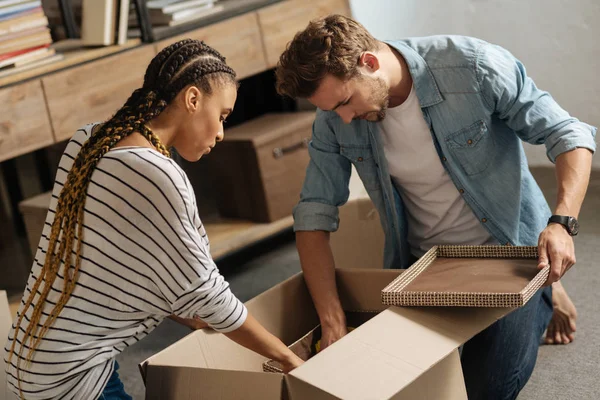 Attentive partners bowing heads while looking downwards — Stock Photo, Image