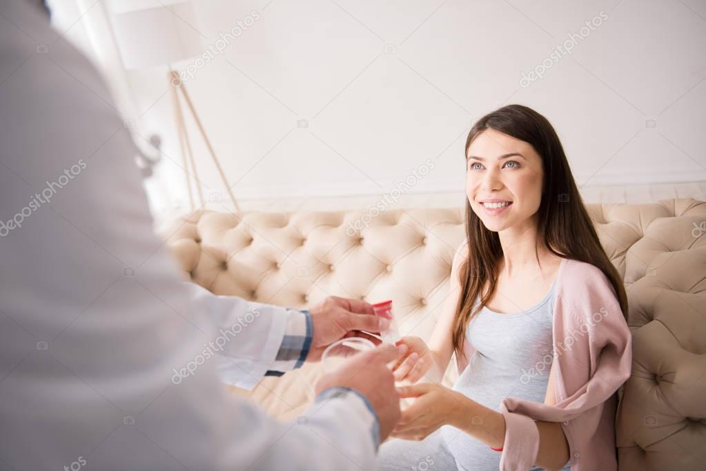 Positive delighted girl being at prenatal clinic