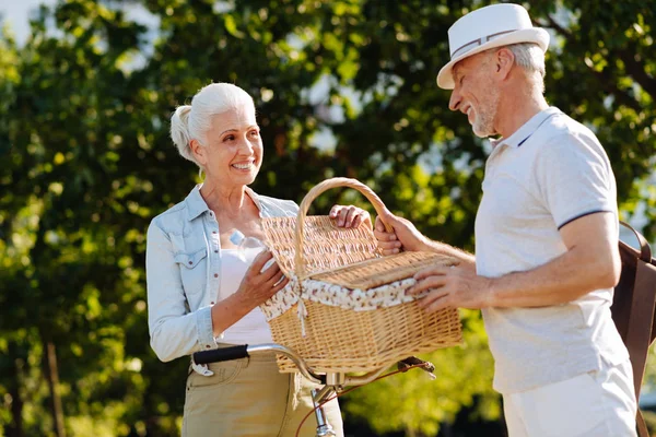 Attractive female opening basket for picnic — Stock Photo, Image