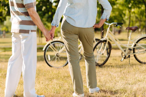 Delighted couple standing opposite their bicycles — Stock Photo, Image