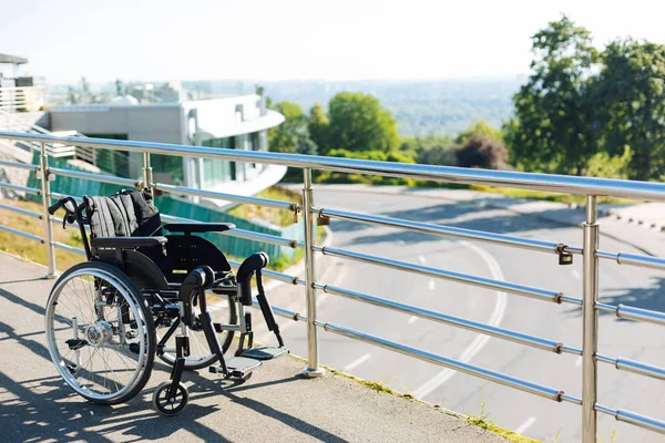 Black new wheelchair left on a terrace — Stock Photo, Image