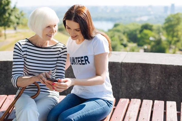 Cheerful curious woman looking on the screen — Stock Photo, Image