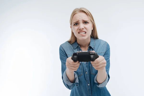 Upset young woman biting her lip — Stock Photo, Image