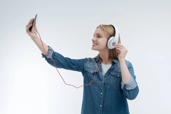 Positive delighted female person taking picture of herself — Stock Photo, Image