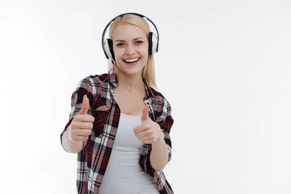 Positive girl raising her thumbs up — Stock Photo, Image