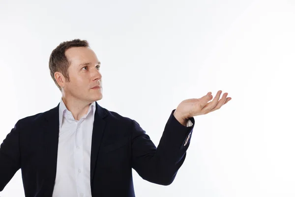 Careful mindful guy holding something in his hand — Stock Photo, Image