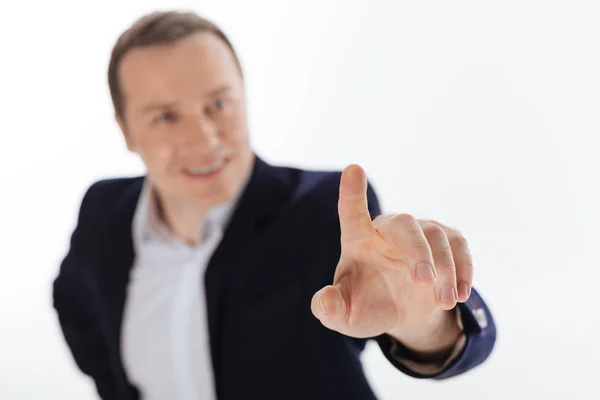 Handsome energetic guy reaching out to touch something — Stock Photo, Image