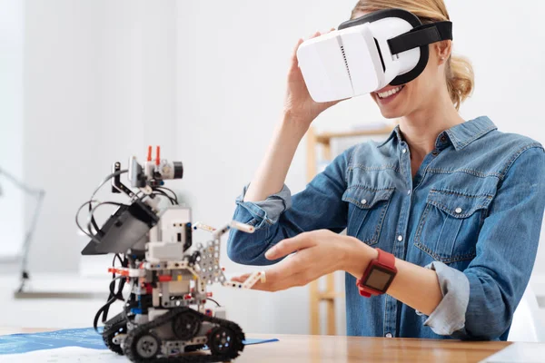 Amused volunteer using visual reality headset in the lab