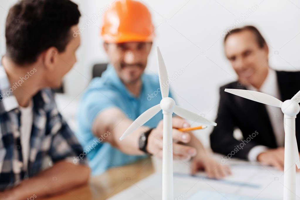 Group of project developers discussing wind turbine models