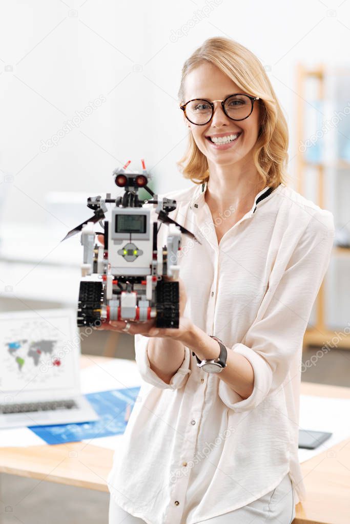 Successful engineer demonstrating futuristic robot in the laboratory