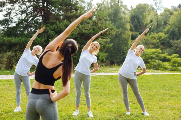 Tres pensionistas haciendo ejercicio con placer — Foto de Stock