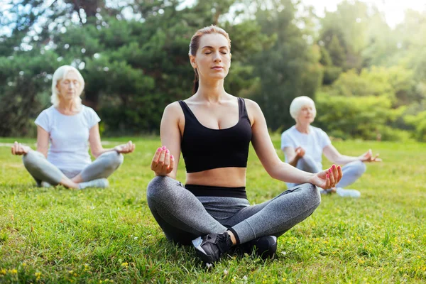 Enigmatical yoga tutor relaxing on fresh air — Stock Photo, Image