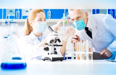 Competent blonde woman working in laboratory clipart
