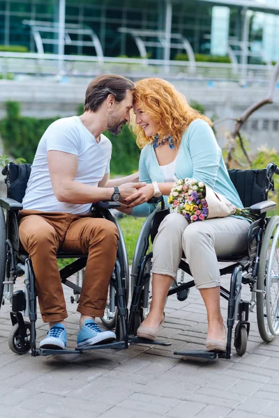 Ανώτερος αγάπη ζευγάρι κάθεται σε αναπηρικές καρέκλες του σε εξωτερικούς χώρους — Φωτογραφία Αρχείου