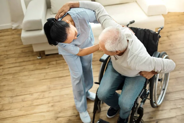 Nice elderly man using caregivers help — Stock Photo, Image