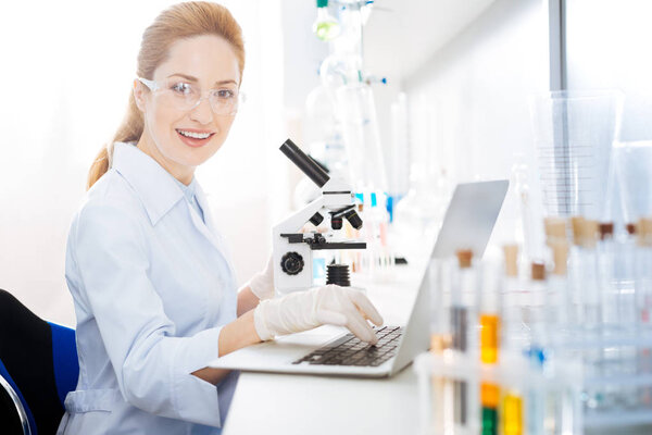Positive delighted female smiling on camera