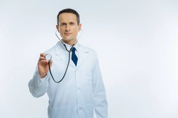 Real medical professional with stethoscope listening to patient heart — Stock Photo, Image