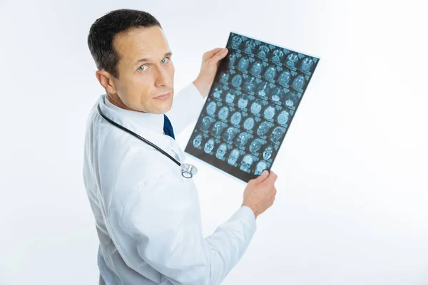 Intellectual medical professional examining mri scan of head — Stock Photo, Image