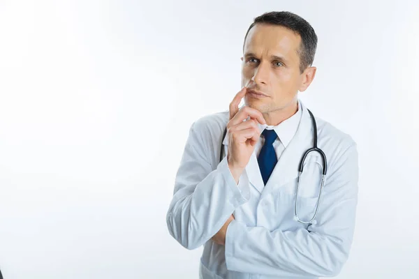 Pensive mature doctor thinking about something — Stock Photo, Image