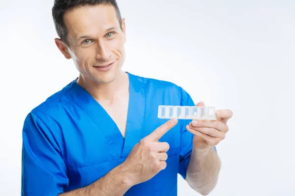 Mature practitioner posing with pills organizer — Stock Photo, Image