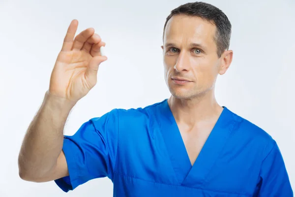 Serious doctor with prescription looking into camera — Stock Photo, Image