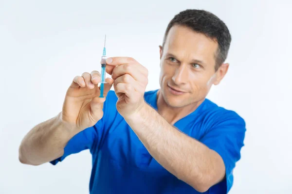 Medical professional testing needle of syringe — Stock Photo, Image
