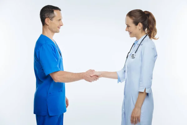 Friendly medical professionals shaking hands