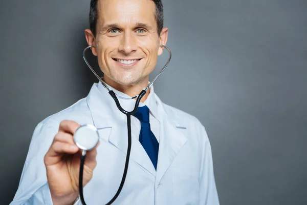 Radiant medical worker with stethoscope beaming into camera — Stock Photo, Image