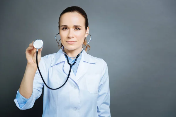 Serious medical specialist listening to patient heart — Stock Photo, Image