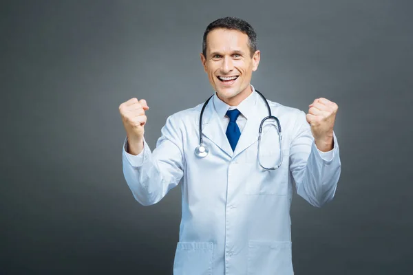 Extremely happy medical professional showing winning sigh — Stock Photo, Image