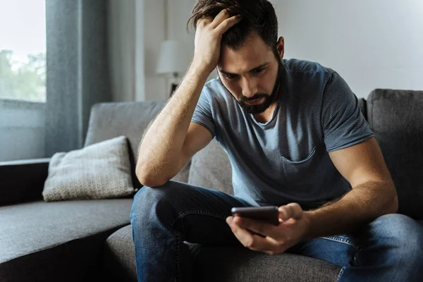 Onun akıllı telefon ekranına bakarak ponponsuz yakışıklı adam