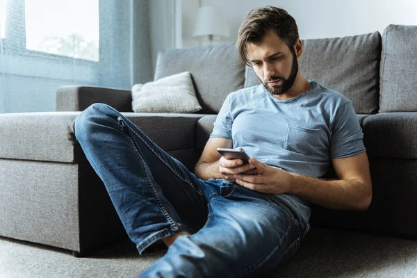 Sad handsome man checking his messages — Stock Photo, Image