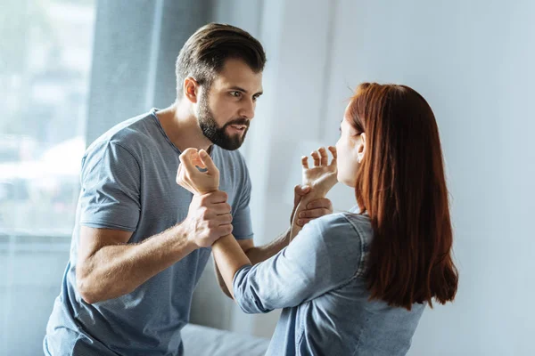Furious brutal man looking at his wife — Stock Photo, Image