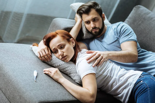 Sad cheerless man caring about his girlfriend — Stock Photo, Image