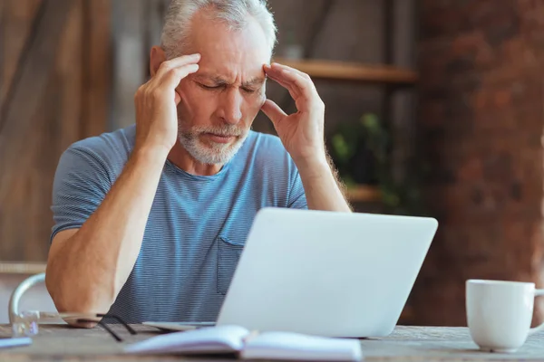 Zieke gepensioneerde man met een hoofdpijn — Stockfoto