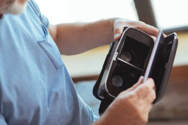 Close up of vr glasses in hands of a pleasant man — Stock Photo, Image