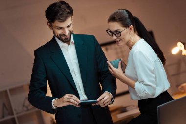 Infatuated office workers watching video clipart