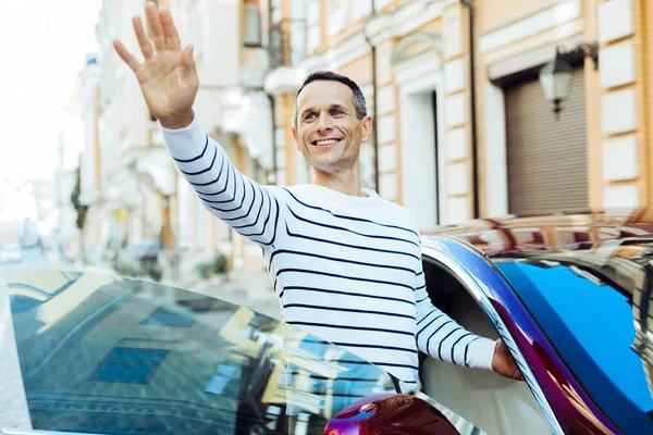 Encantado hombre agradable sosteniendo su mano —  Fotos de Stock