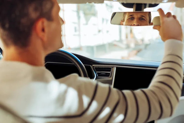 Joyful homem positivo olhando para o espelho retrovisor — Fotografia de Stock