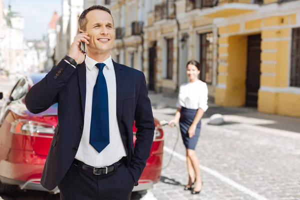 Encantado empresario positivo poniendo una mano en su bolsillo — Foto de Stock