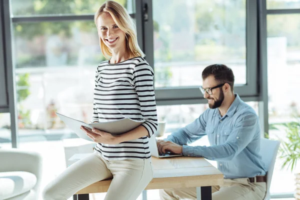 Smiling woman studying new materials in the office