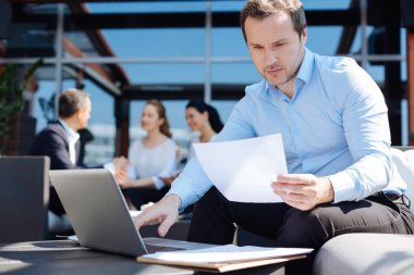 İyi görünümlü profesyonel girişimci belgeyi okuyan