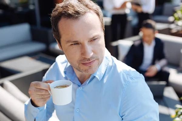 Serious thoughtful man drinking espresso — Stock Photo, Image