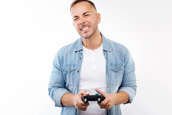 Young man grimacing after losing in video game — Stock Photo, Image