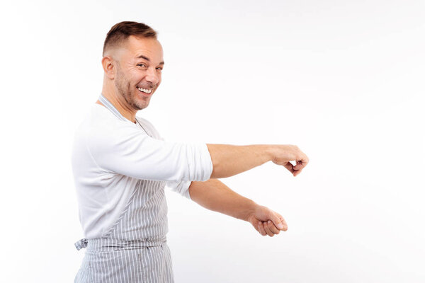 Joyful man imitating the process of salting dishes